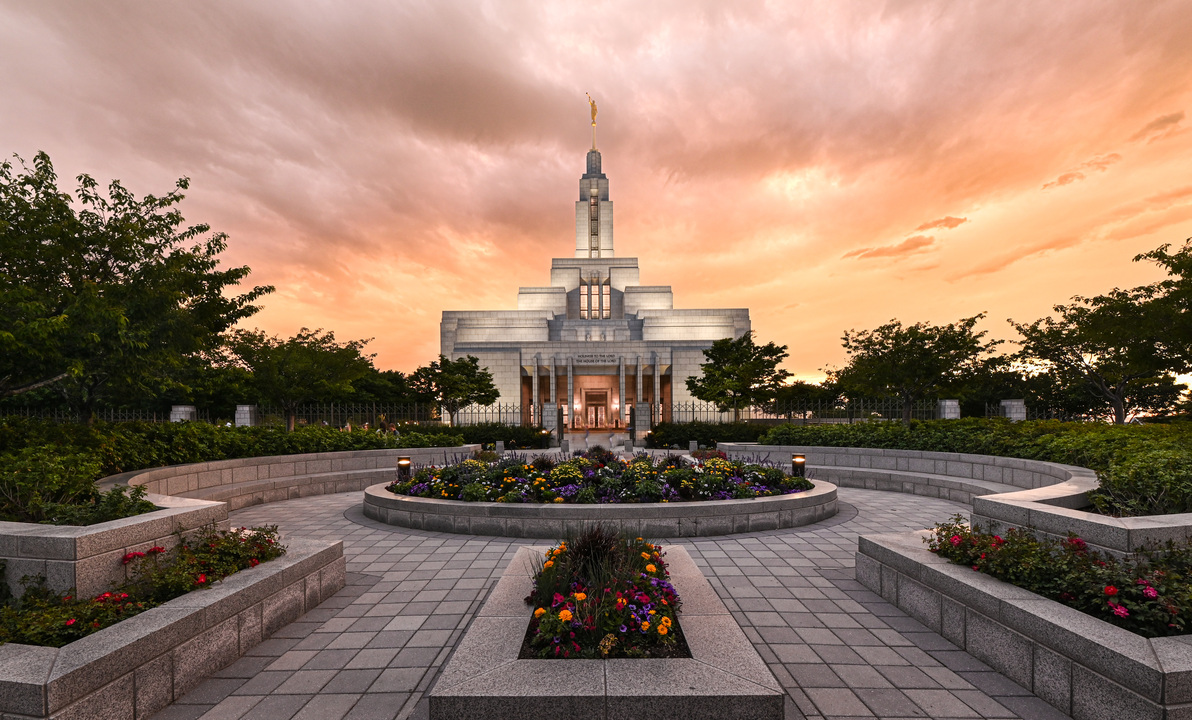 Draper Utah Temple and gardens beneath a sunset sky